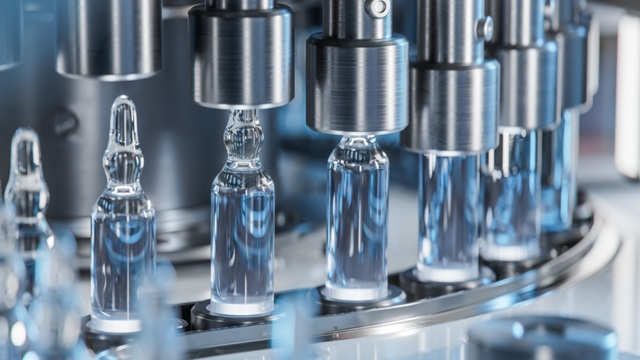 Automated production line filling medical ampoules at a pharmaceutical factory.
