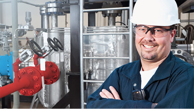 smiling engineer at printed circuit heat exchanger installation